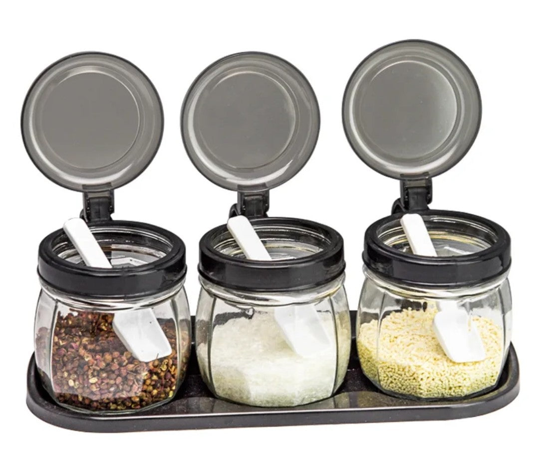 Glass condiment set with flip top black lid and tray
