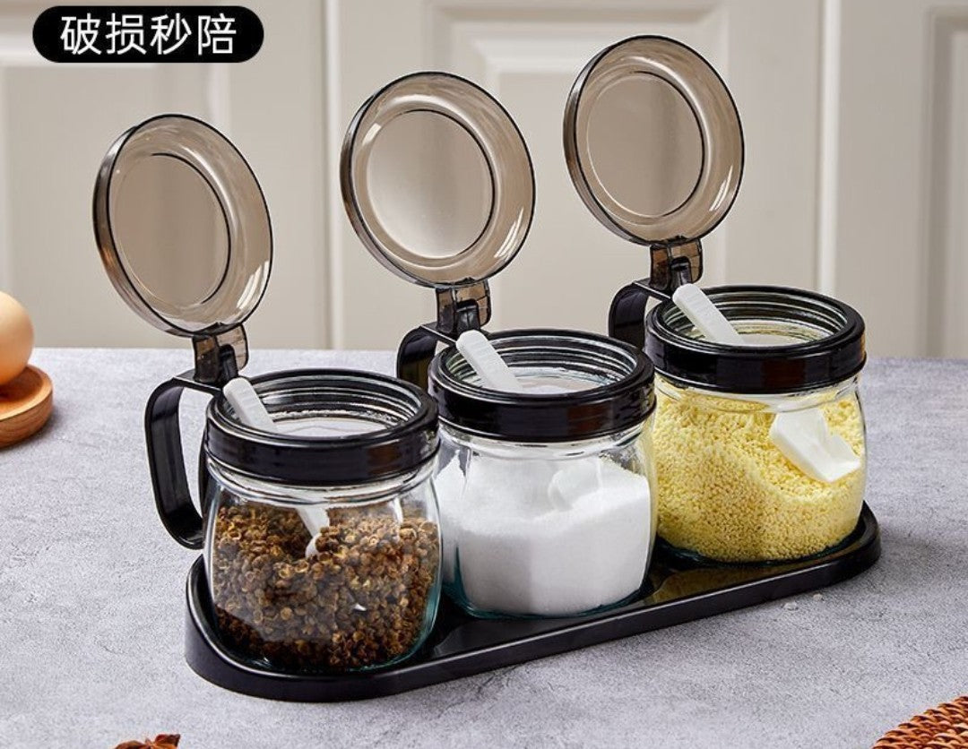 Glass condiment set with flip top black lid and tray