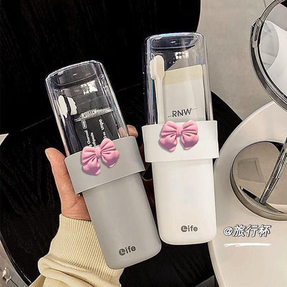 Travel toothbrush/toothpaste holder with a pink decorative bow